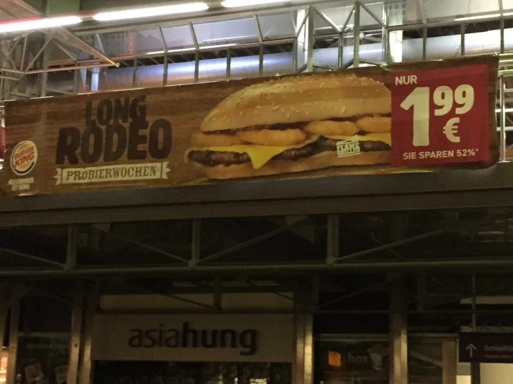 a large sign that has a giant burger on it