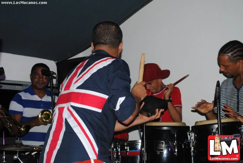 men in union jack costumes playing music on a stage