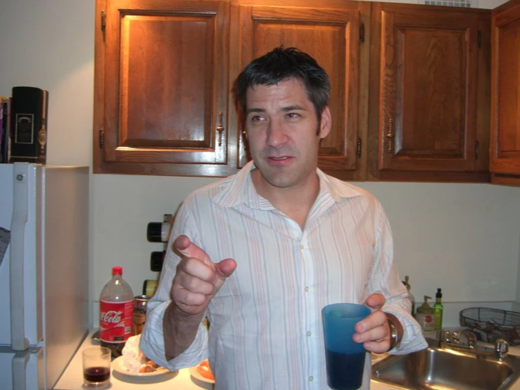 a man holds a glass of liquid with both hands