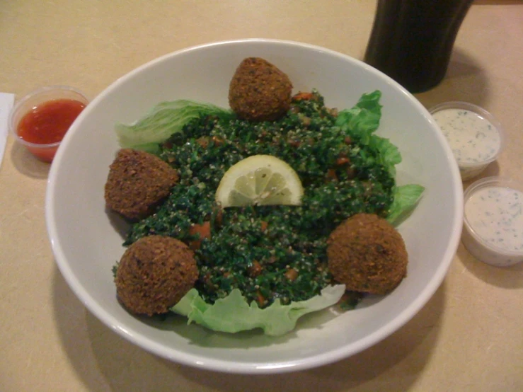 a bowl on a table topped with some meatballs