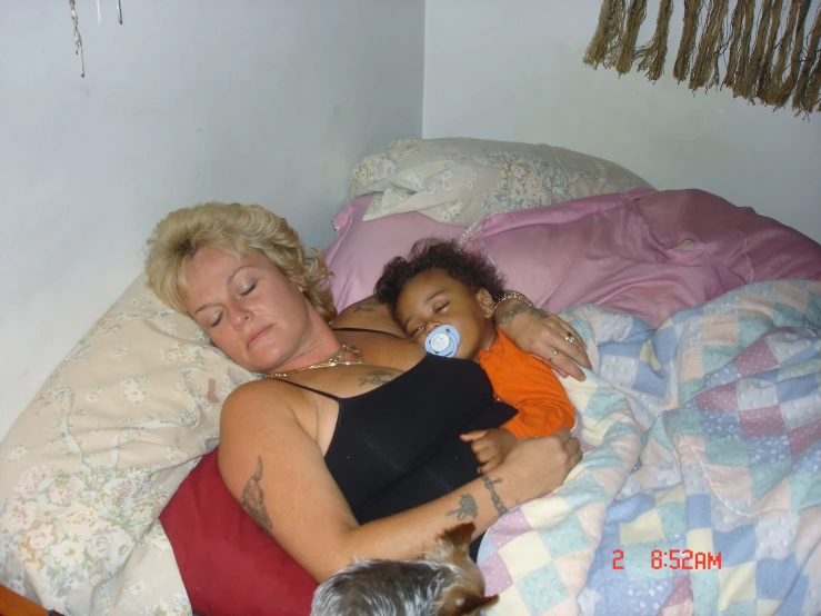 an older woman and young child sleeping on a bed