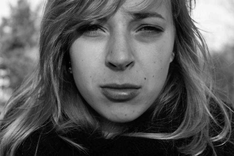 a woman with freckles standing outside in the cold