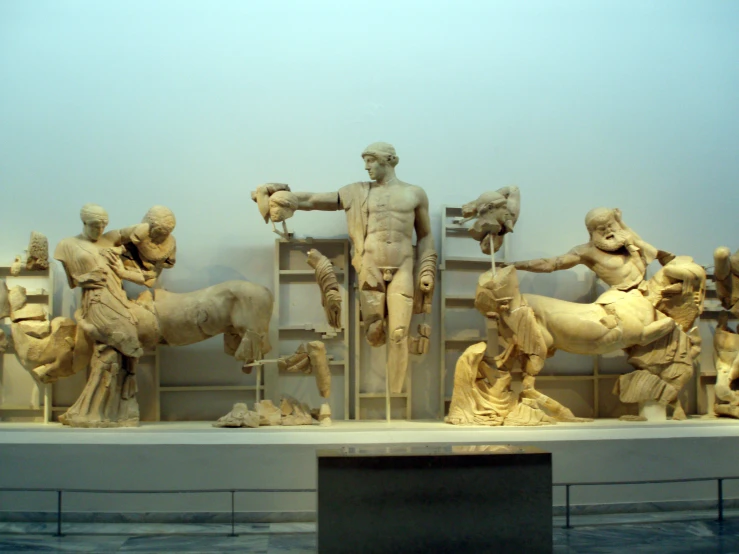 sculptures in an art museum on display including horses and humans