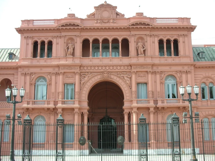 an elaborate building with statues and many windows