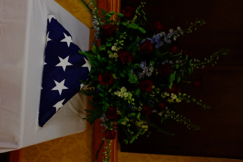 some red, white, and blue flowers in an american flag centerpiece