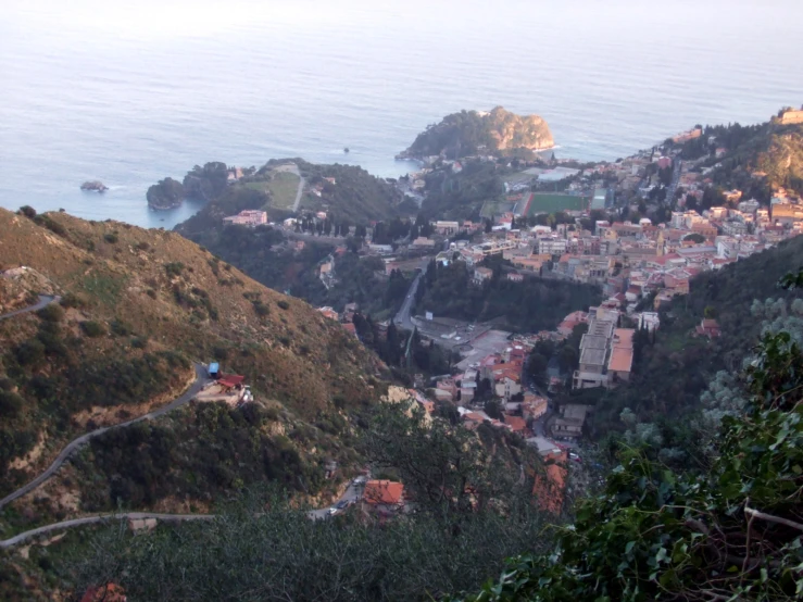 an aerial view of a town next to the ocean