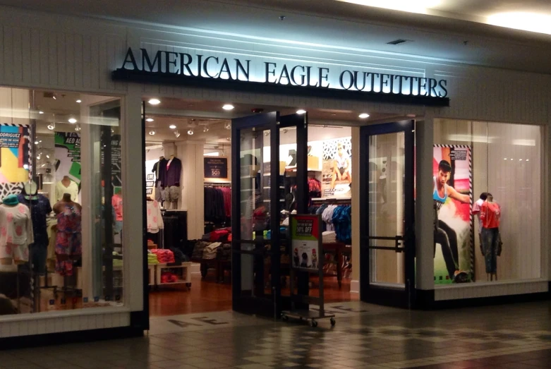 people are walking in the shop front to an american eagle outfitters store