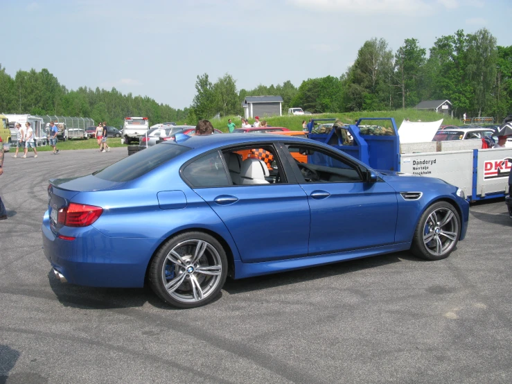 the blue car is parked in a lot