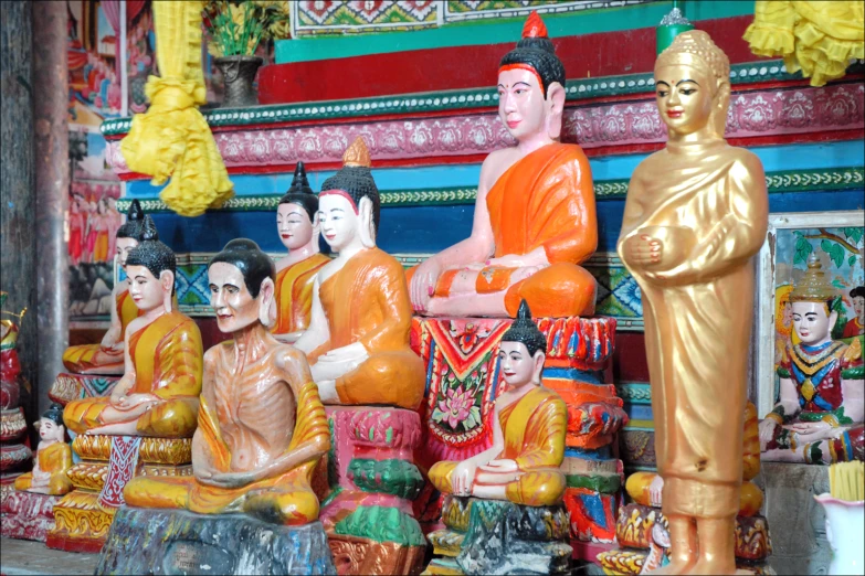 many orange statues are sitting in front of each other