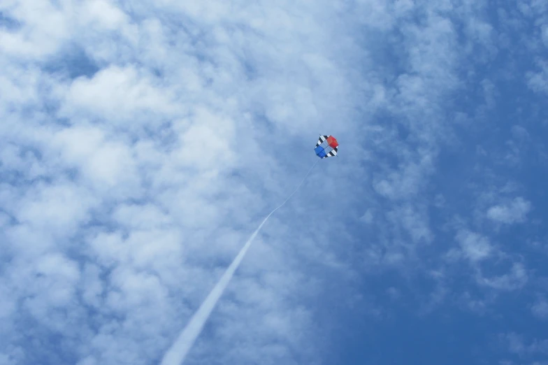 kite in the air as it flies by