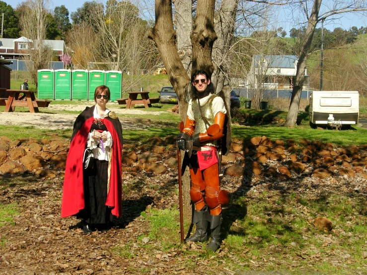 two people are dressed in costume on a dirt path
