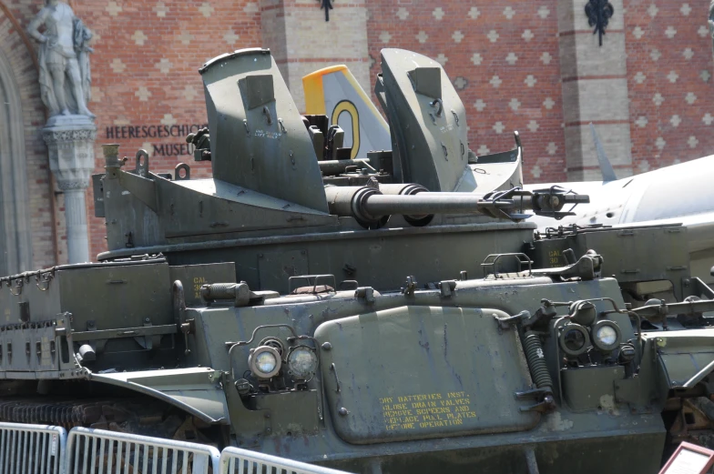 an old military vehicle parked on top of a parking lot