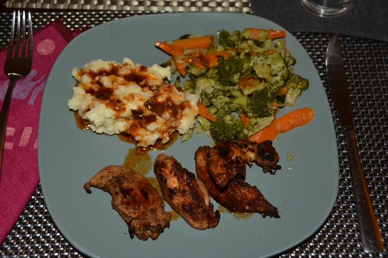 a plate of food containing chicken and mashed potatoes