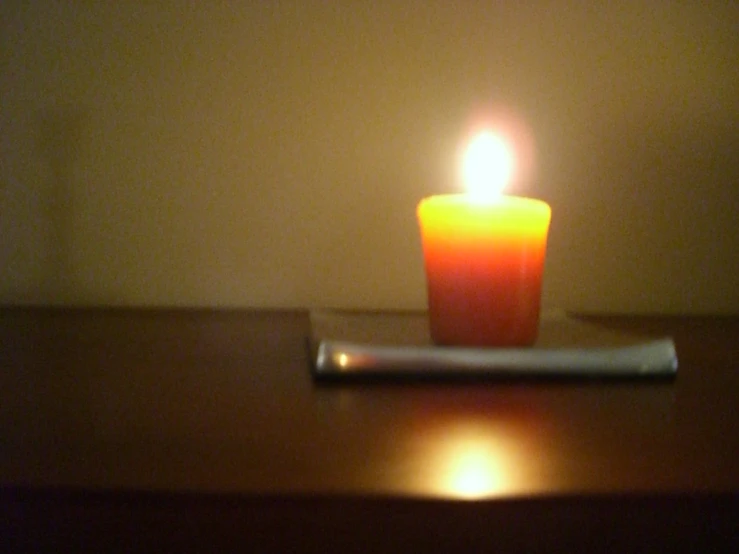 a candle sitting on top of a wooden table