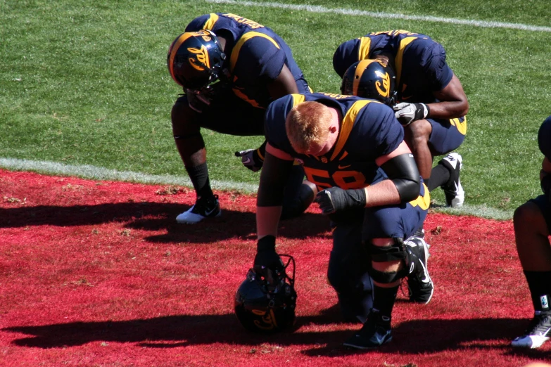 the football players are playing on the field