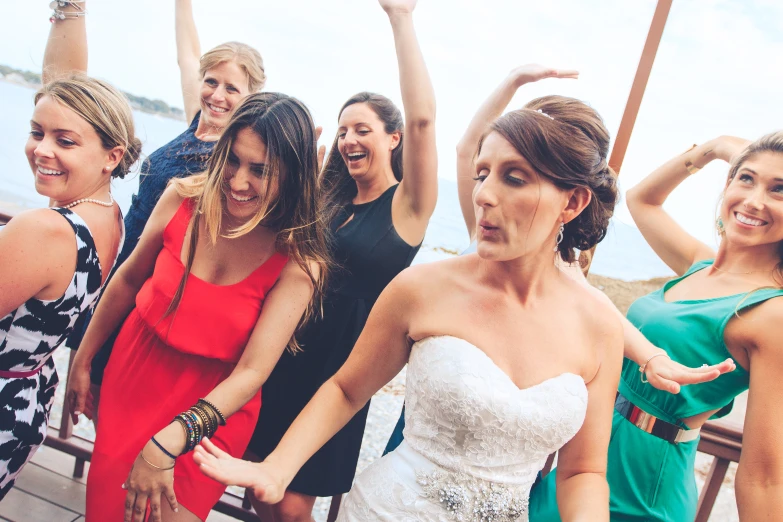 a group of women in colorful dresses doing an awkward pose