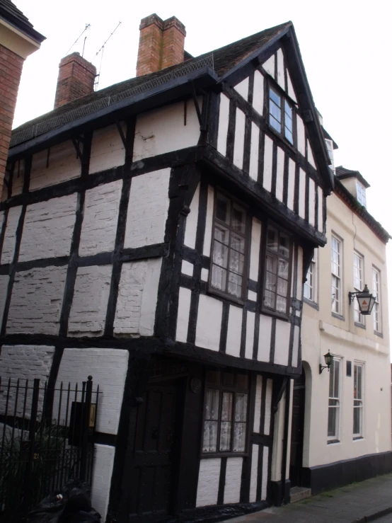 a black and white building sitting on the side of a road