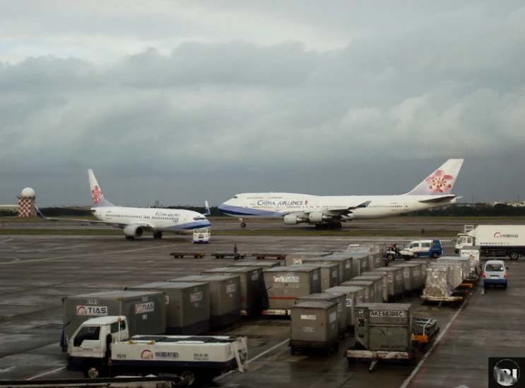 two airplanes parked next to each other on a runway