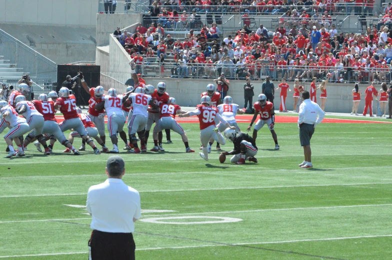 a football game in action with several people watching