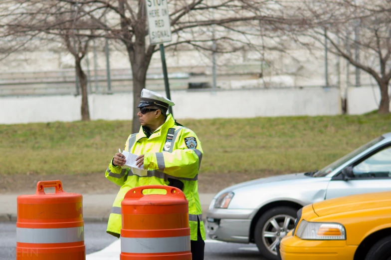 a traffic officer is talking to traffic cones
