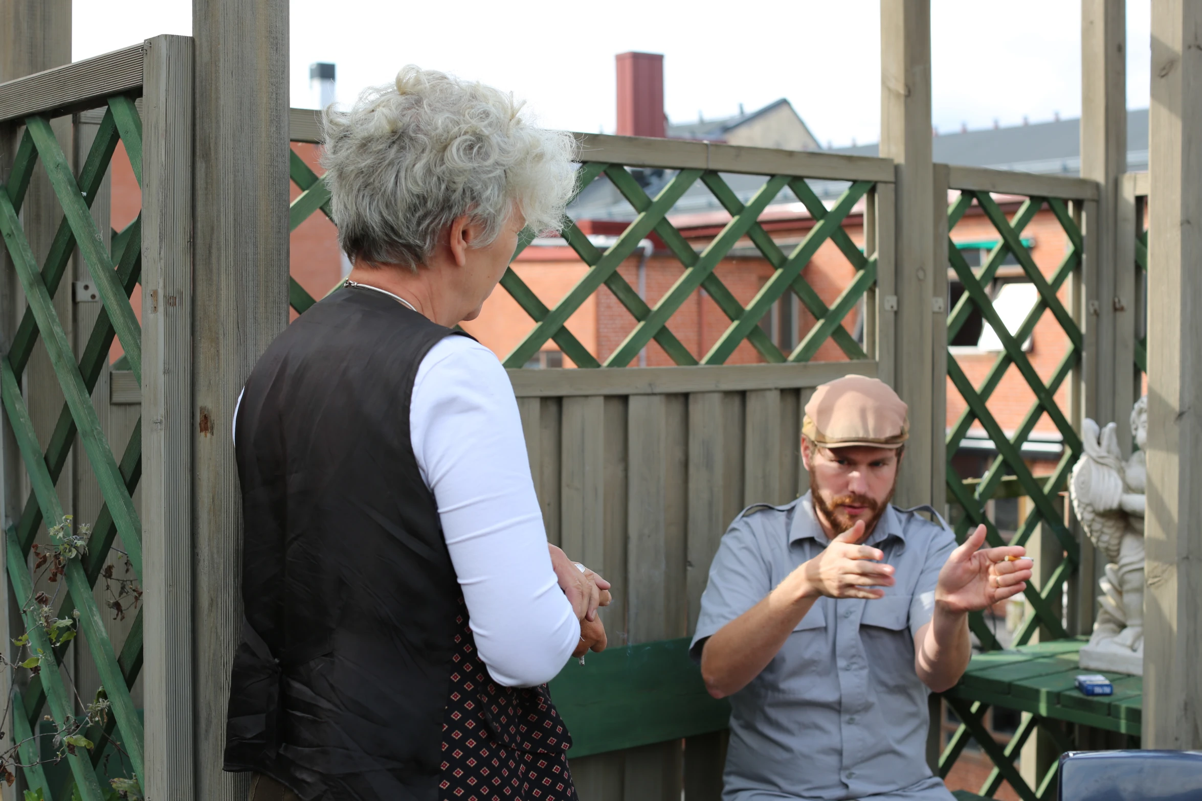 a man with white hair standing next to an older lady