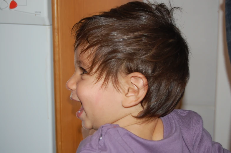 a close up of a little girl with very dark hair