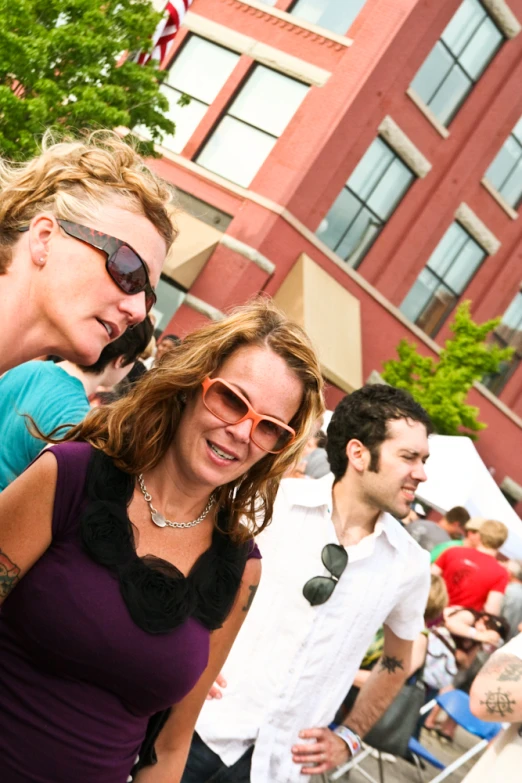 a woman smiling and another women carrying her hand