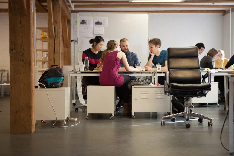 people sitting at desk in an office setting with computers