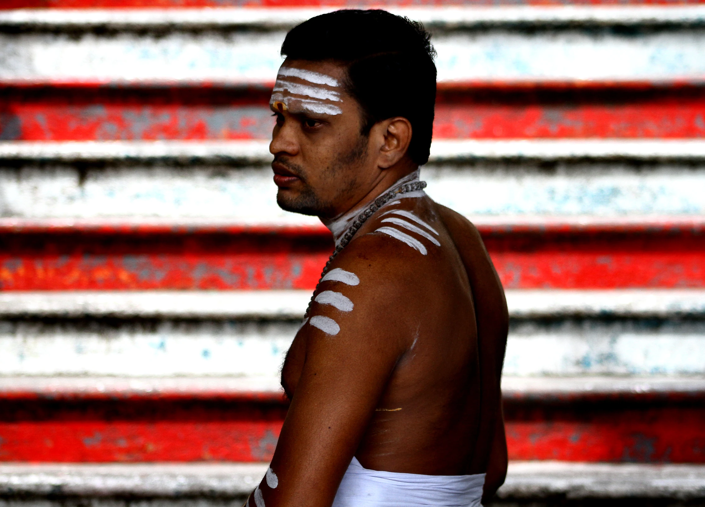 a man wearing white paint painted on his face