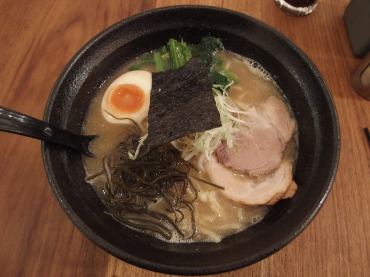 the bowl contains a bunch of ramen and a variety of ingredients