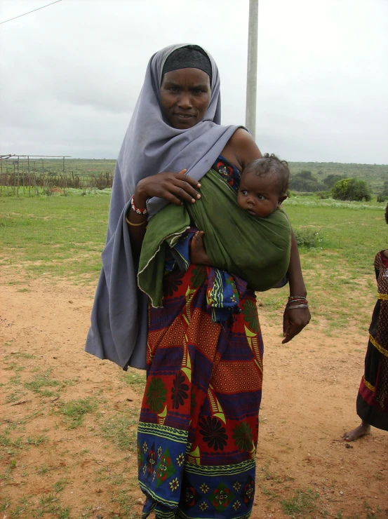 a woman in a scarf holding a child