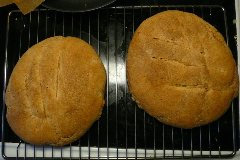 two round breads sitting on top of a cooking grill