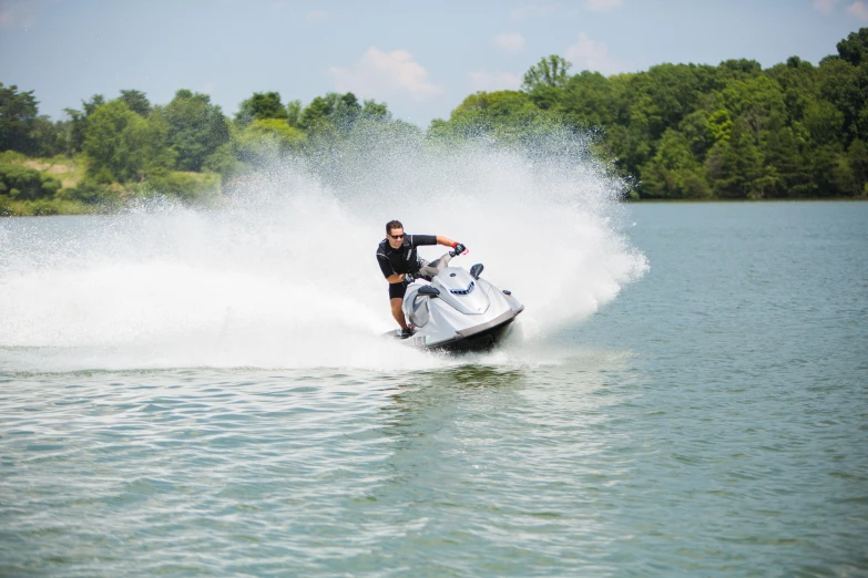 a person on skis splashing water as a jet ski