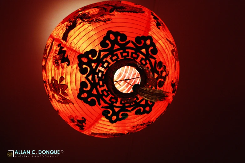 an orange oriental lamp on a dark room