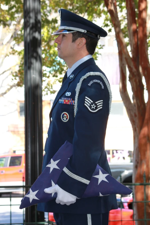 a soldier holds up the flag for people