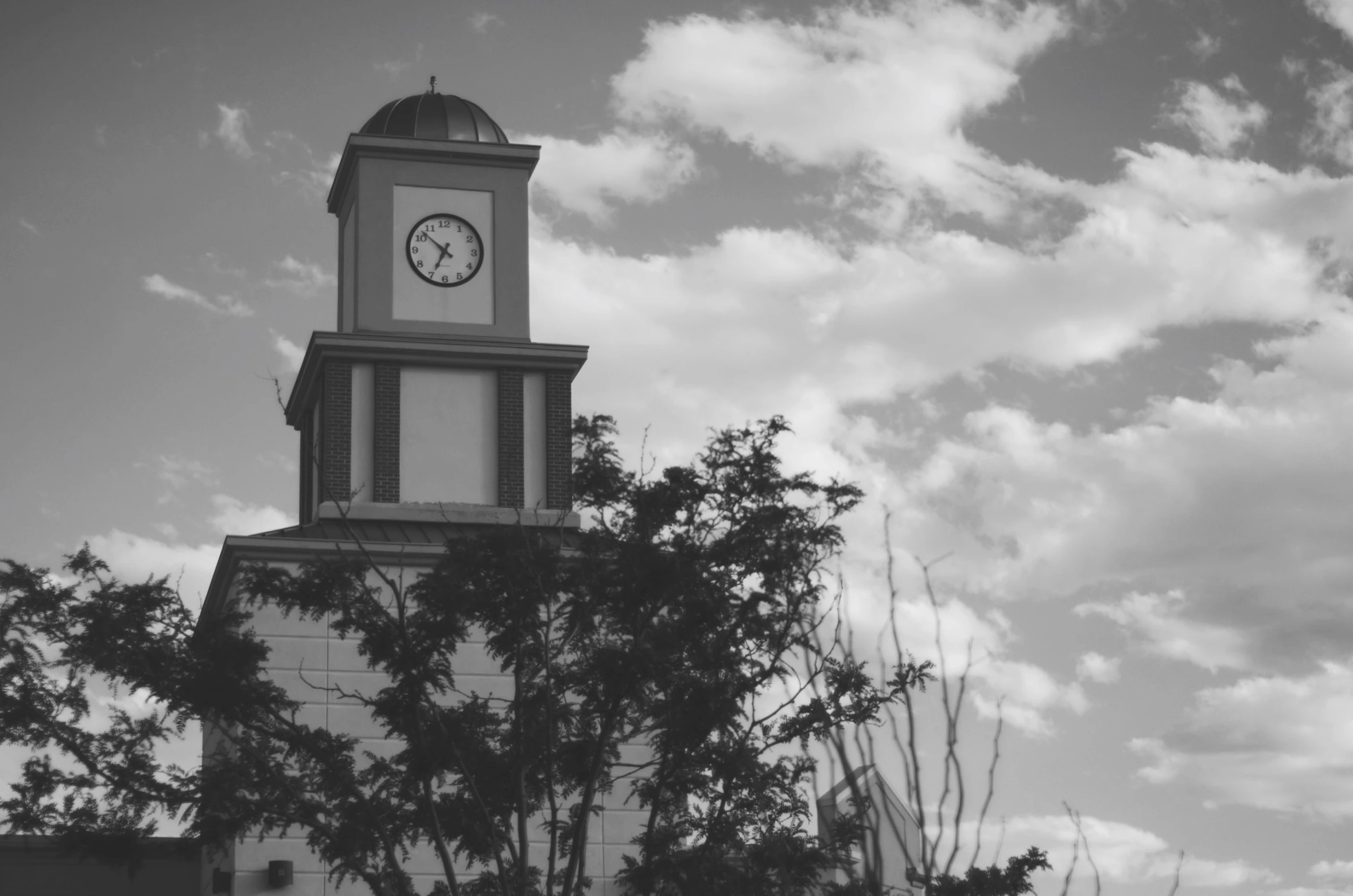 a clock tower is shown in the black and white po