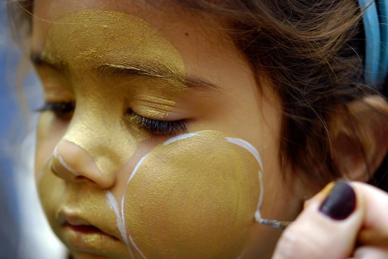  having painted face art with gold