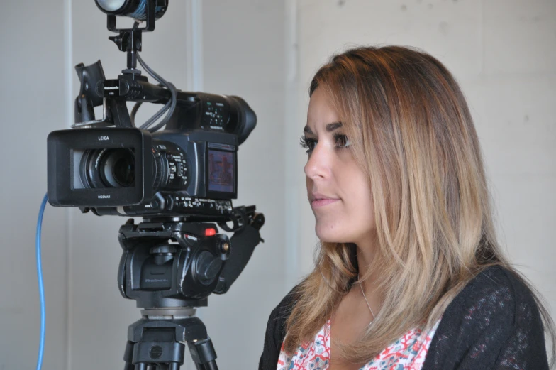 a woman is standing in front of a camera