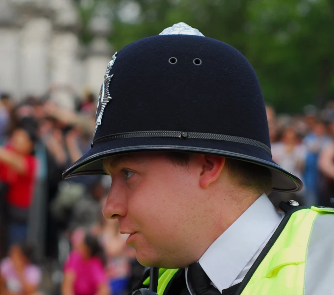 a policeman in a yellow vest and blue hat