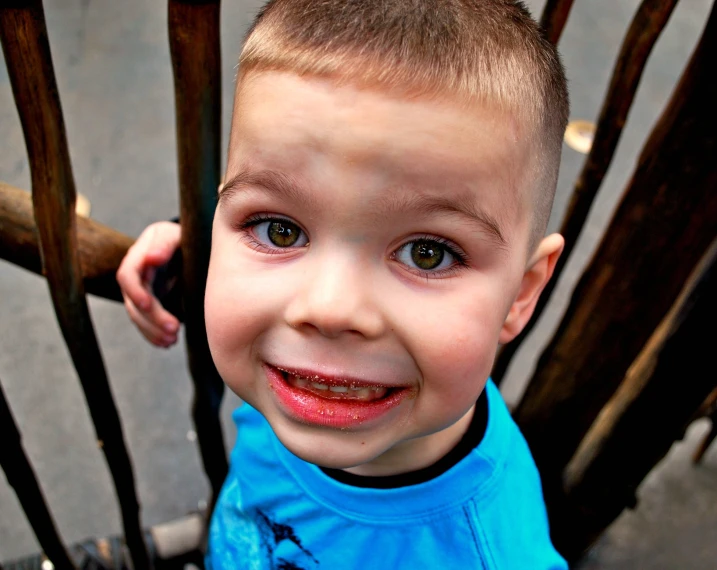 a  sitting on a chair outside and smiling at the camera