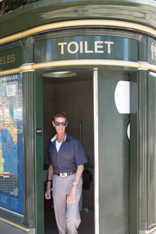 a man standing in the doorway to a toilet