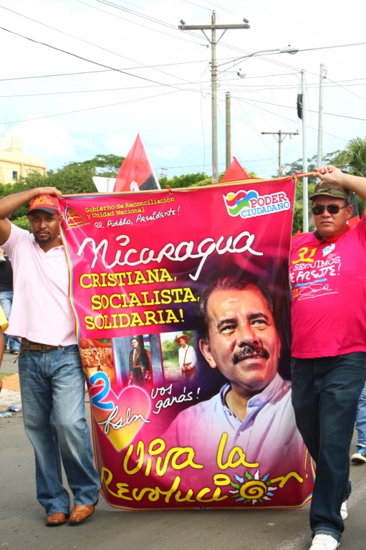 two men with a banner on the street