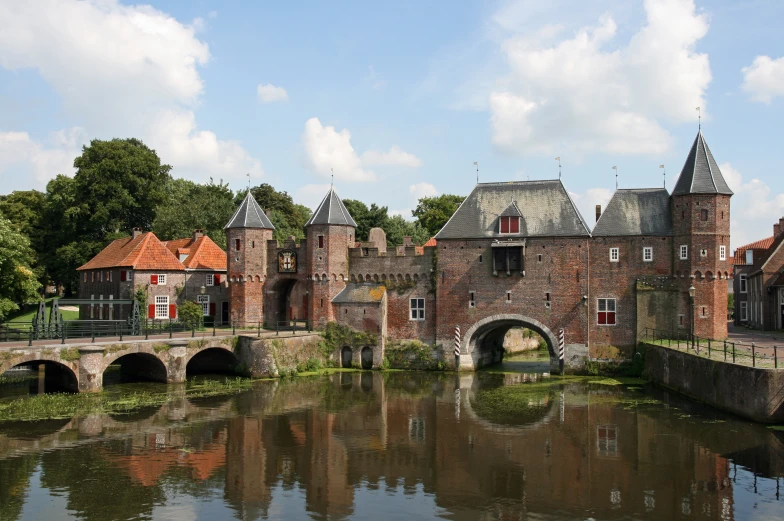 a castle with an arched bridge in front