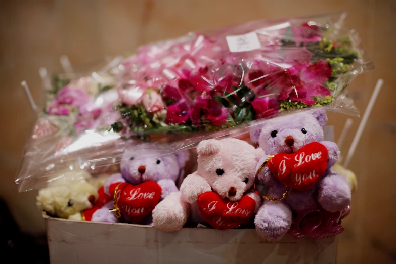 a dozen stuffed animals holding valentine's day hearts