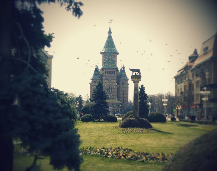 a building with a tower stands in the middle of the grass