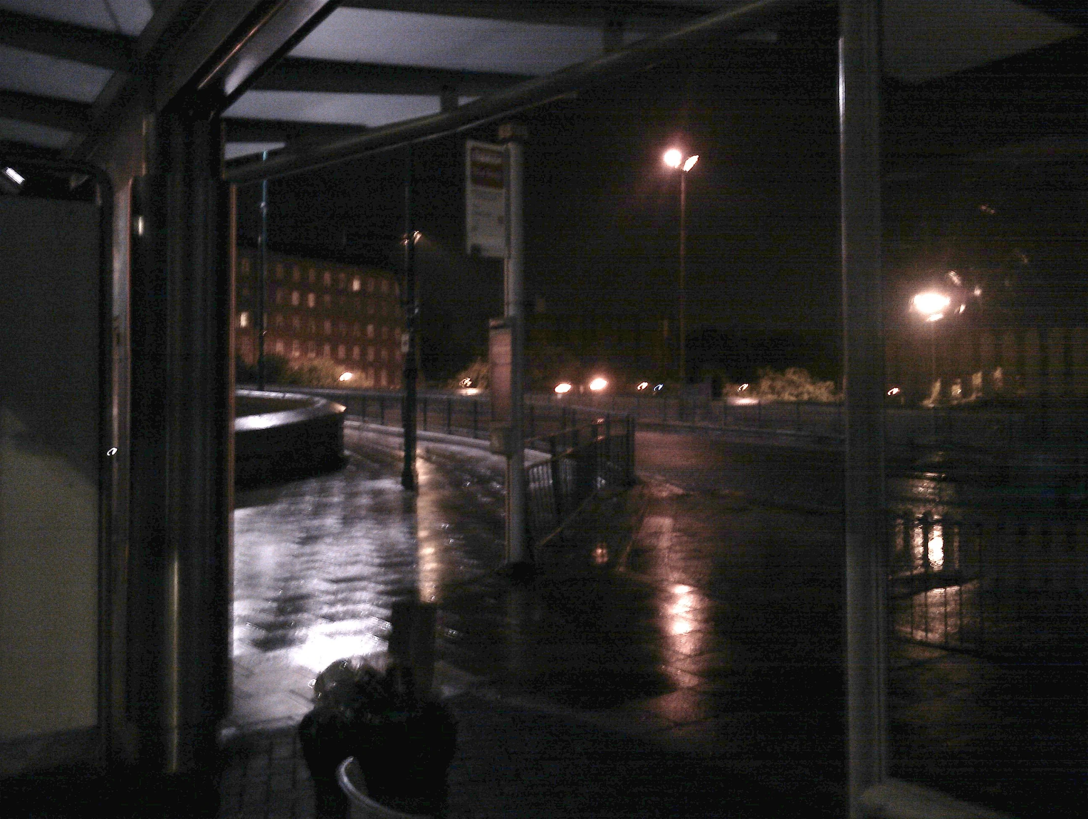 an empty parking lot with cars and street lights