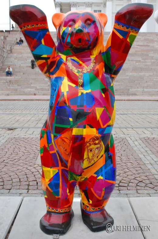 a bear statue on a sidewalk in front of a building