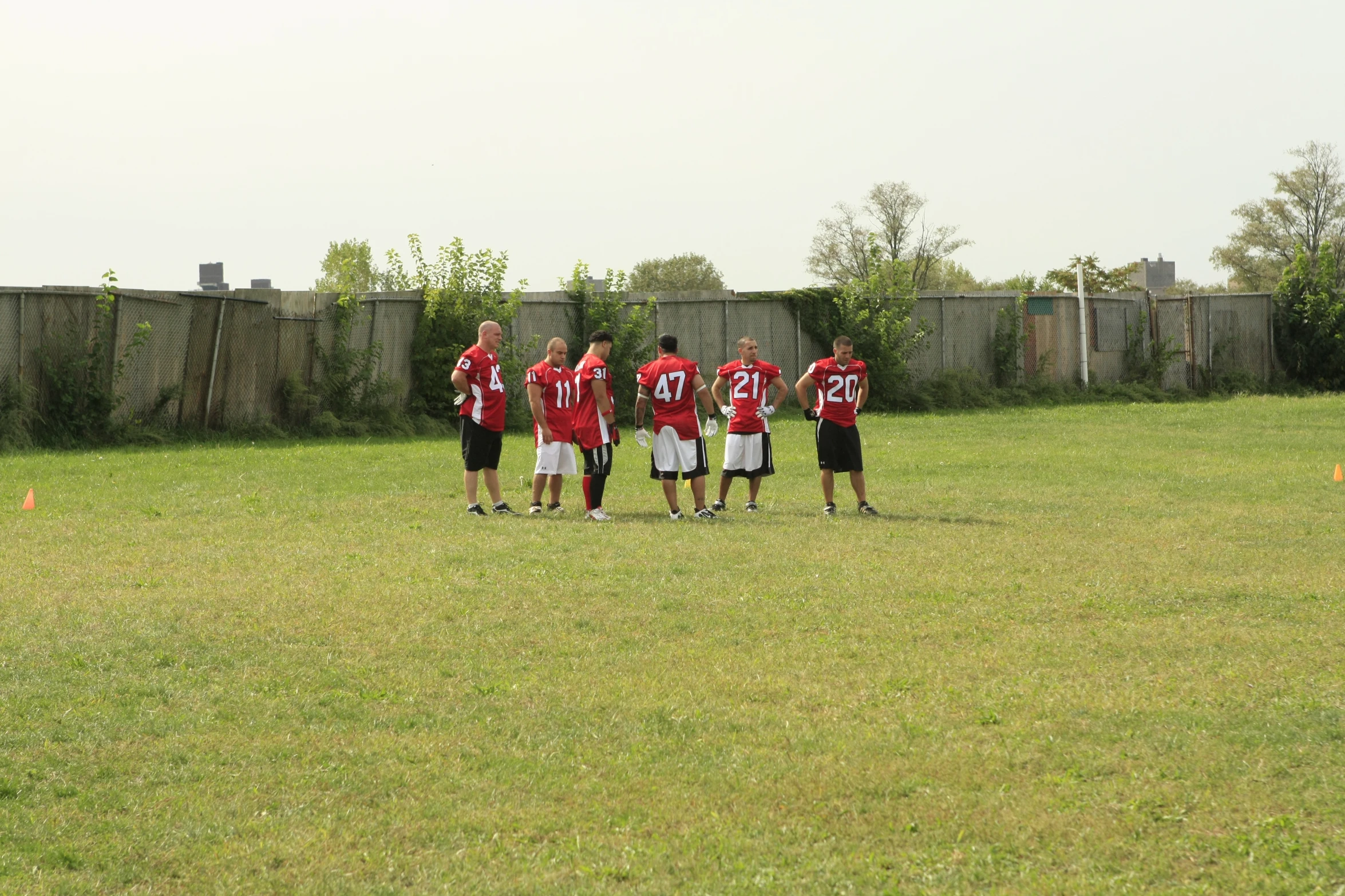 two teams of soccer players standing on top of a field