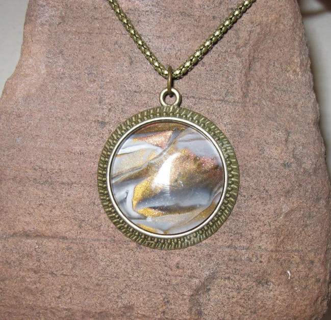 a necklace with an image of birds inside