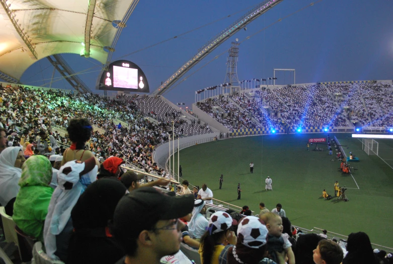 a soccer match with fans at the stands